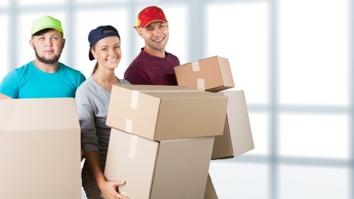 Packed boxes and furniture ready for collection by removal van