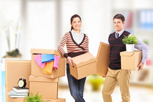 Professional movers preparing furniture with safety awareness and care