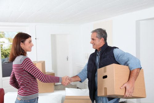 Professional movers handling furniture in a Scottish flat