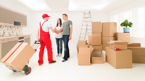Removal team handling furniture in a Scottish property